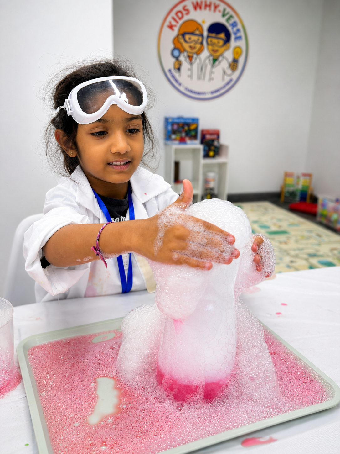 A child creating pink bubbles during a science workshop
